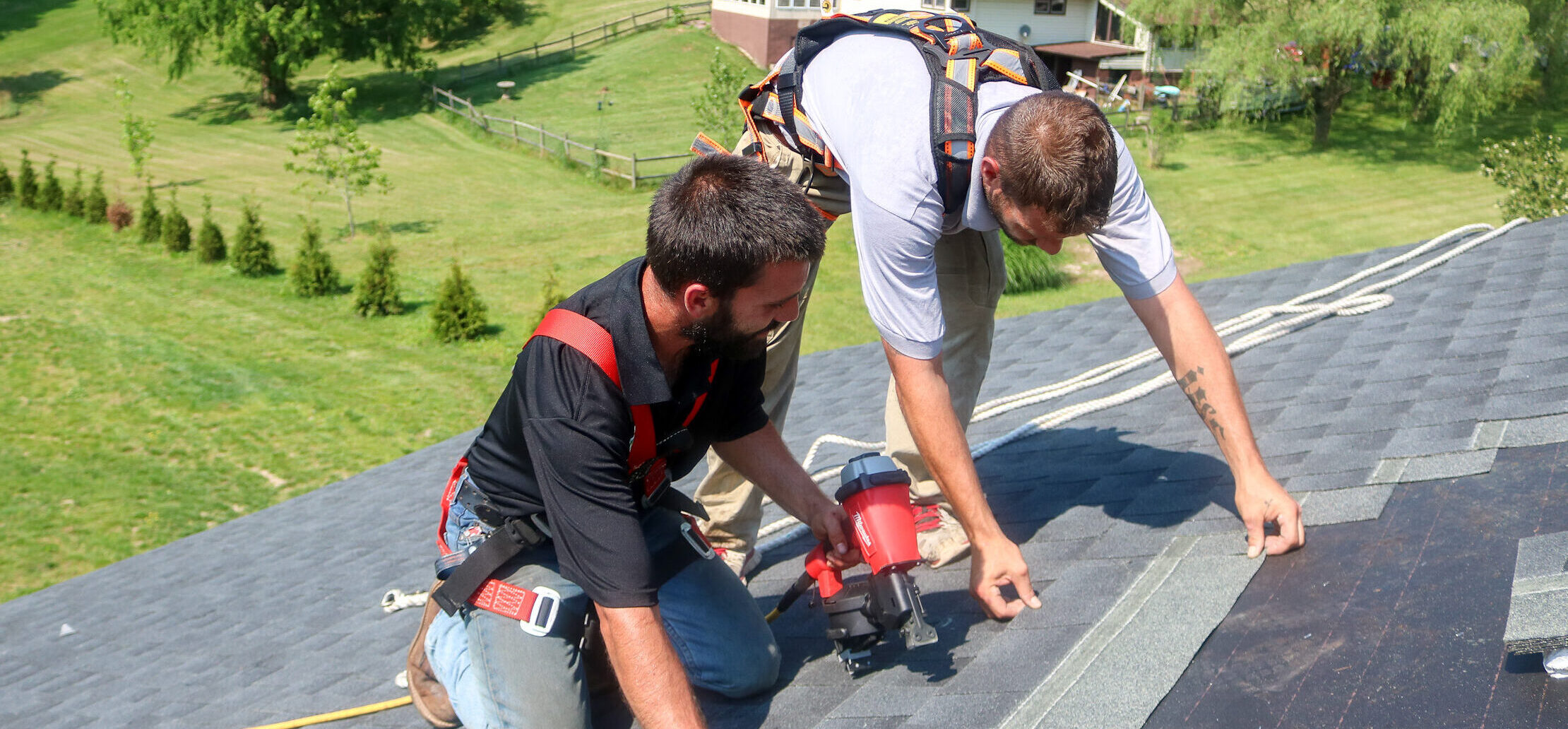 two team members installing roof